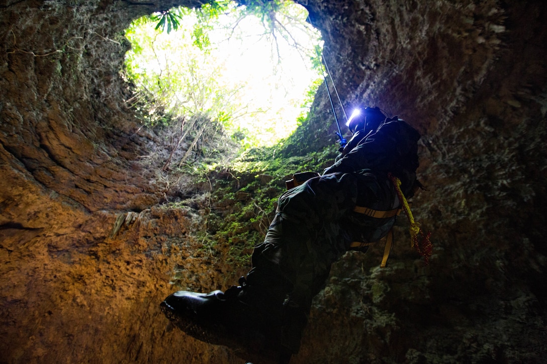 A U.S. Marine ascends out of a cave in mission oriented protective posture gear on Marine Corps Air Station Futenma, Okinawa, Japan on April 19, 2018, Chemical, biological, radiological, and nuclear Marines conducted simulated site exploitation to detect chemical or radiological threats in areas that are difficult to access. The Marines are CBRN specialists with Headquarters Battalion, 3rd Marine Division.