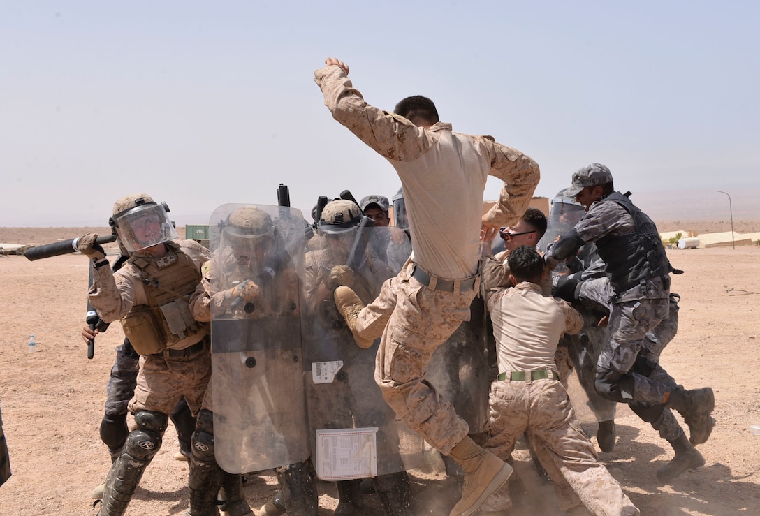U.S. Marines with Fleet Anti-Terrorism Security Team Central Command and Jordanian 77th Marines Battalion train together in riot control measures during exercise Eager Lion 2018, April 18, 2018. Eager Lion is a capstone training engagement that provides U.S. forces and the Jordan Armed Forces an opportunity to rehearse operating in a coalition environment and to pursue new ways to collectively address threats to regional security and improve overall maritime security.