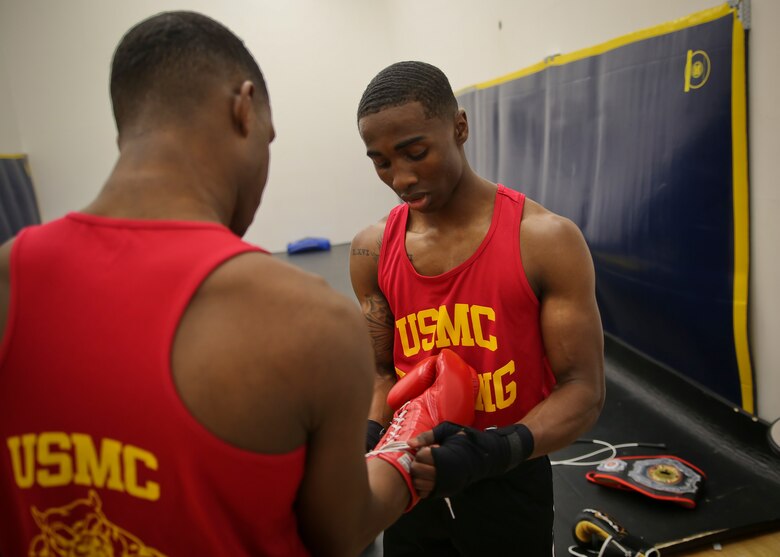 Cpl. Oubigee Jones assists Lance Cpl. Keandre Blackshire before sparring aboard Marine Corps Air Station Beaufort April 17. Lance Cpl. Keandre Blackshire, Cpl. Malik Collins, and Cpl. Oubigee Jones fought in the Marine Corps and Chevrolet Freedom Fight exhibition aboard Marine Corps Base Camp Lejeune April 14. The Marines were able to represent the Marine Corps Boxing Team in the exhibition match and had the opportunity to fight in front of retired and current boxing legends. The Marines are Administrative Specialists with the Installation Personnel Administrative Center.