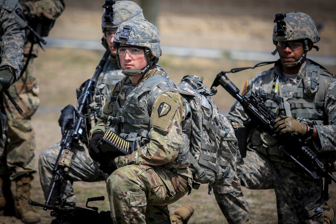 Soldiers wait for orders before conducting live-fire battle drills.