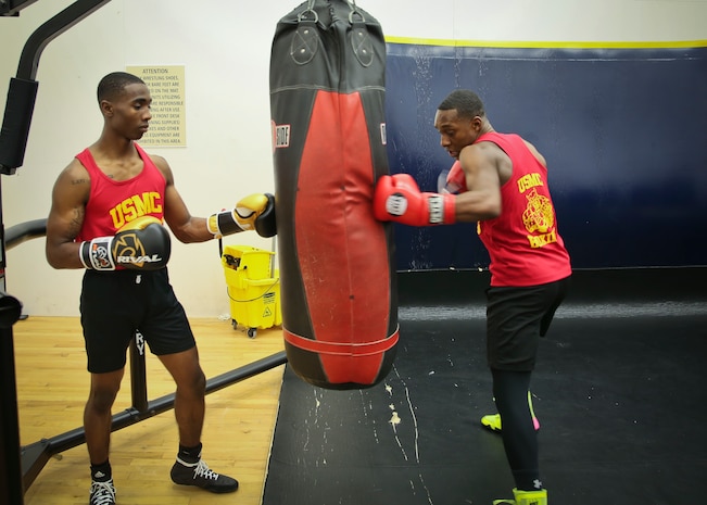 Cpl. Oubigee Jones assists Lance Cpl. Keandre Blackshire practice striking techniques aboard Marine Corps Air Station Beaufort April 17. The Marines fought in the Marine Corps and Chevrolet Freedom Fight exhibition aboard Marine Corps Base Camp Lejeune April 14. Jones and Blackshire are Administrative Specialists with the Installation Personnel Administrative Center.
