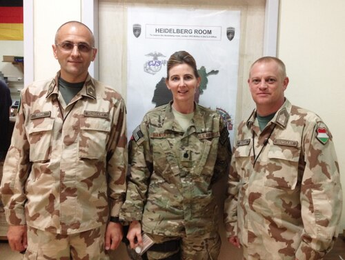 Then-Lt. Col. Lisa Banyasz-de Silva, a reserve division chief with Air Force Reserve Command (AFRC), poses for a photo with two members of the Hungarian military while assigned to the Combined Joint Operations Center during a 2014 NATO deployment at Kabul International Airport, Afghanistan. Banyasz-de Silva, who is also a civilian nurse, provides programming and oversight of medical professionals and financial resources for 82 reserve medical units. She also develops policy and training to enable medical units to produce combat ready Airmen. (Courtesy photo)