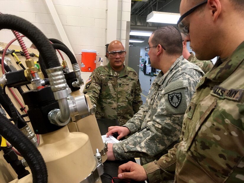 Sgt. 1st Class Gilbert Galman, a 94th Training Division instructor at Regional Training Site - Maintenance (RTS-M) Devens, prepares his students for a classroom test reviewing the fundamentals of maintaining an automatic fire extinguinshing system on a wheeled vehicle during the 91B Wheeled Vehicle Mechanic Course, 28 March 2018. Galman currently holds the mantle of Instructor of the Year at RTS-M Devens after the leadership chose him in October 2017 following a rigorous board selection process. He went on to represent Devens the next month at the 2017 Instructor of the Year competition sponsored by the 80th Training Command (TASS). According to his supervisors, Galman pushes his students to excel and his passion and dedication enhances the entire team at RTS-M Devens. (U.S. Army Reserve photo by Master Sgt. Benari Poulten, 80th Training Command)