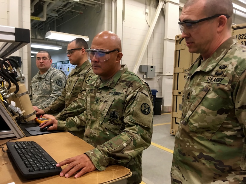 Sgt. 1st Class Gilbert Galman, a 94th Training Division instructor at Regional Training Site - Maintenance (RTS-M) Devens, reviews the digital results of a student's diagnostic preventative maintenance checks and services test during the 91B Wheeled Vehicle Mechanic Course, 28 March 2018. Galman currently holds the mantle of Instructor of the Year at RTS-M Devens after the leadership chose him in October 2017 following a rigorous board selection process. He went on to represent Devens the next month at the 2017 Instructor of the Year competition sponsored by the 80th Training Command (TASS). According to his supervisors, Galman pushes his students to excel and his passion and dedication enhances the entire team at RTS-M Devens. (U.S. Army Reserve photo by Master Sgt. Benari Poulten, 80th Training Command)