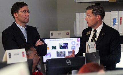 Charles Canedy (right), chief of the commander’s action group for U.S. Army North (Fifth Army), briefs the 23rd Secretary of the Army, Dr. Mark T. Esper on the functionality of ARNORTH’s Defense Support of Civil Authorities mission April 17 at the Joint Operations Center inside the historic Quadrangle at Joint Base San Antonio-Fort Sam Houston.The DSCA mission focuses on the Department of Defense’s Chemical, Biological, Radiological and Nuclear Response Enterprise, which provides support to the federal lead agency in the event of a catastrophic national disaster.