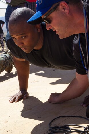 A Marine from the Marine Corps Air Ground Combat Center, Twentynine Palms, Calif., competes in the push-up contest at the inaugural Tug-of-War Competition hosted by the Desert Refuge for Peace Officers and Military Personnel in Joshua Tree, Calif., April 14, 2018. The event also included barbecue lunch, live music, giveaways and inter-faith prayer services. (U.S. Marine Corps photo by Cpl. Dave Flores)