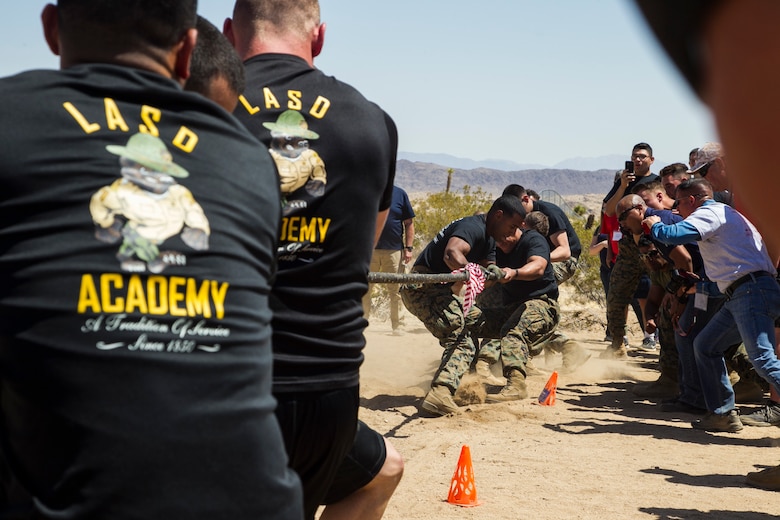 Marines from the Marine Corps Air Ground Combat Center and deputies from the Los Angeles County Sheriff’s Department battle each other in a tug-of-war match at the inaugural Tug-of-War Competition hosted by the Desert Refuge for Peace Officers and Military Personnel in Joshua Tree, Calif., April 14, 2018. The event also included a barbecue lunch, live music, giveaways and inter-faith prayer services. (U.S. Marine Corps photo by Cpl. Dave Flores)