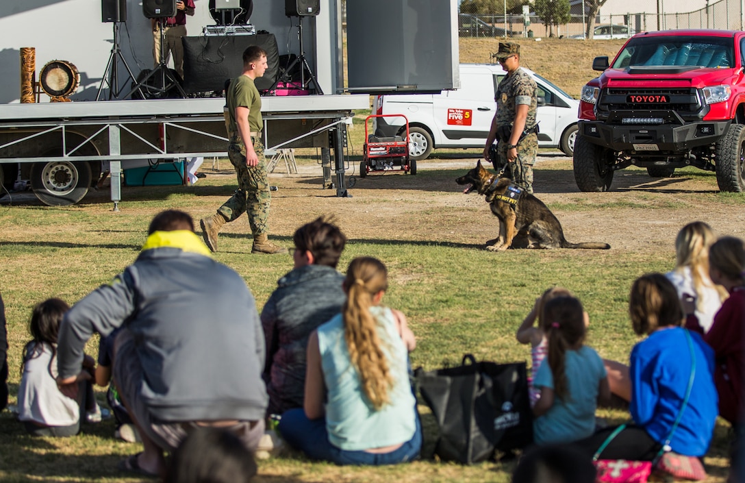 Marines with the Military Working Dog section of the Provost Marshal’s Office, participate in a K-9 demonstration during the 4th Annual Earth Day Extravaganza aboard the Marine Corps Air Ground Combat Center, Twentynine Palms, Calif., April 13, 2018. The purpose of the extravaganza is to bring families together and educate them on how to be better stewards of the Earth’s resources. (U.S. Marine Corps photo by Lance Cpl. Rachel K. Porter)