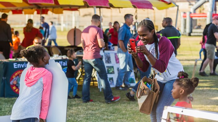 Alesha Smith, wife of Staff Sgt. Brian Smith, communication security manager, 3rd Light Armored Reconnaissance Battalion, takes a photo of her daughter during the 4th Annual Earth Day Extravaganza aboard the Marine Corps Air Ground Combat Center, Twentynine Palms, Calif., April 13, 2018. The purpose of the extravaganza is to bring families together and educate them on how to be better stewards of the Earth’s resources. (U.S. Marine Corps photo by Lance Cpl. Rachel K. Porter)