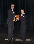 Capt. Howard Markle, Puget Sound Naval Shipyard & Intermediate Maintenance Facility commander, presents ND1 (DWS/EXW) Eric Lehman, a diver with PSNS & IMF Everett Detachment, with the PSNS & IMF Everett Detachment's Junior Sailor of the Year Award during the Employee of the Year Ceremony, March 29, 2018, at the Admiral Theatre in Bremerton, Washington. (U.S. Navy photo by Carie Hagins, PSNS & IMF photographer)