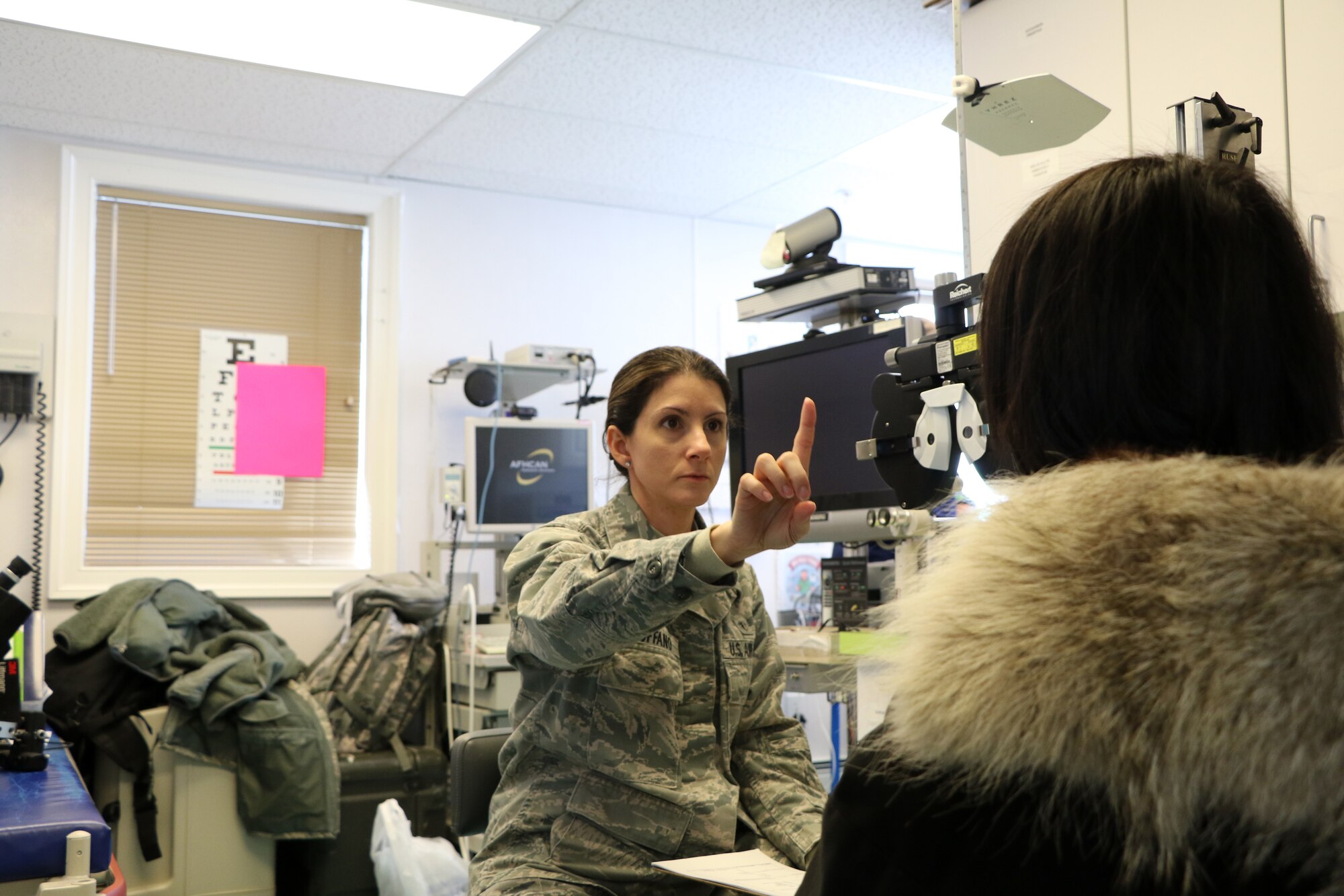 Captain Roxanne Buffano, an optometrist assigned to the 927th Aerospace Medicine Squadron, MacDill AFB FL, conducts an eye exam April 17 in support of Arctic Care 2018, at the Kivalina Clinic, Kivalina, Alaska. Arctic Care 2018 is an Innovative Readiness Training exercise comprised of a joint and multi-national force providing medical, dental, optometry and veterinary care for underserved villages in the Maniillaq Service Area April 16-24. (U.S. Air Force photo by Maj. Joe Simms)