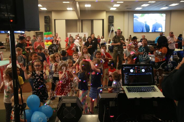 Children dance to music at the Child Abuse Awareness and Military Child Appreciation Carnival aboard the Marine Corps Air Ground Combat Center, Twentynine Palms, Calif., April 12, 2018. The event was held to provide available resources to community members and hold a small fair for children. (U.S. Marine Corps photo by Lance Cpl. Preston L. Morris)