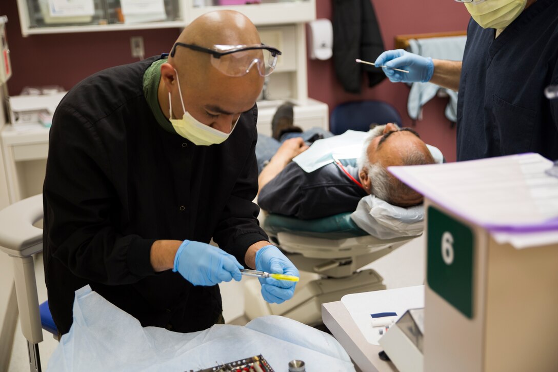 Navy Petty Officer 2nd Class Adrian B. Echevarri, dental leading petty officer with 4th Dental Battalion, 4th Marine Logistics Group, prepares dental tools prior to conducting a dental procedure on a local citizen during Innovative Readiness Training Arctic Care 2018, Kotzebue, Alaska, April 19, 2018.