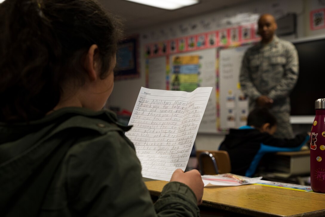A student from the Kotzebue Elementary School reads a letter she wrote to the service members of Innovative Readiness Training Arctic Care 2018 during a career day at the school to thank them for all they are doing for the Northwest Arctic Borough, Kotzebue, Alaska, April 19, 2018.