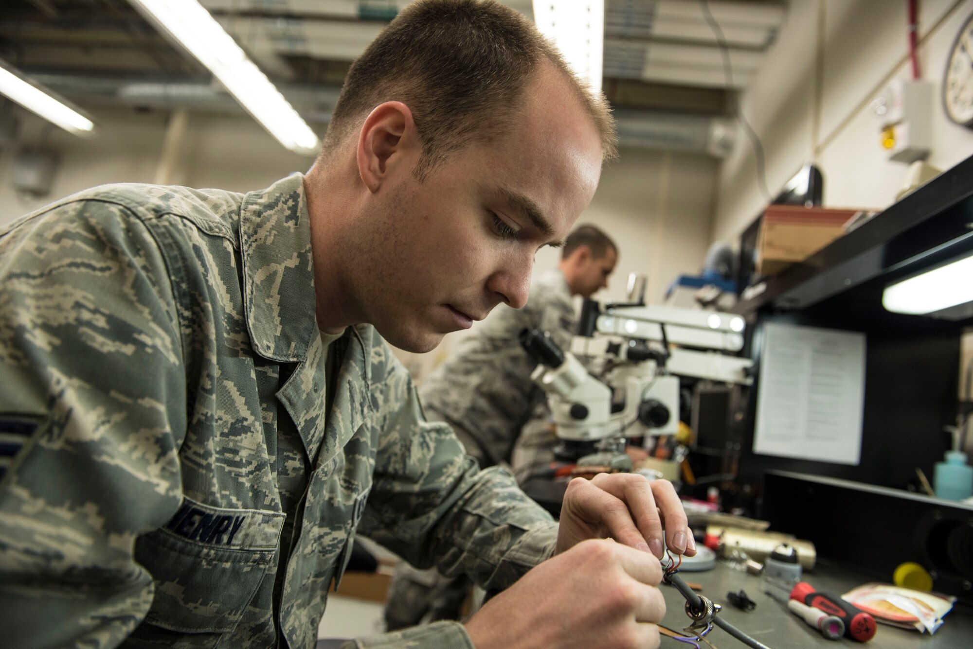 U.S. Air Force Staff Sgt. Brandon Henry, front, and Staff Sgt. Alexander Creznic, 20th Maintenance Group Air Force Repair Enhancement Program technicians, work on weight and balance kit cables at Shaw Air Force Base, S.C., April 20, 2018.
