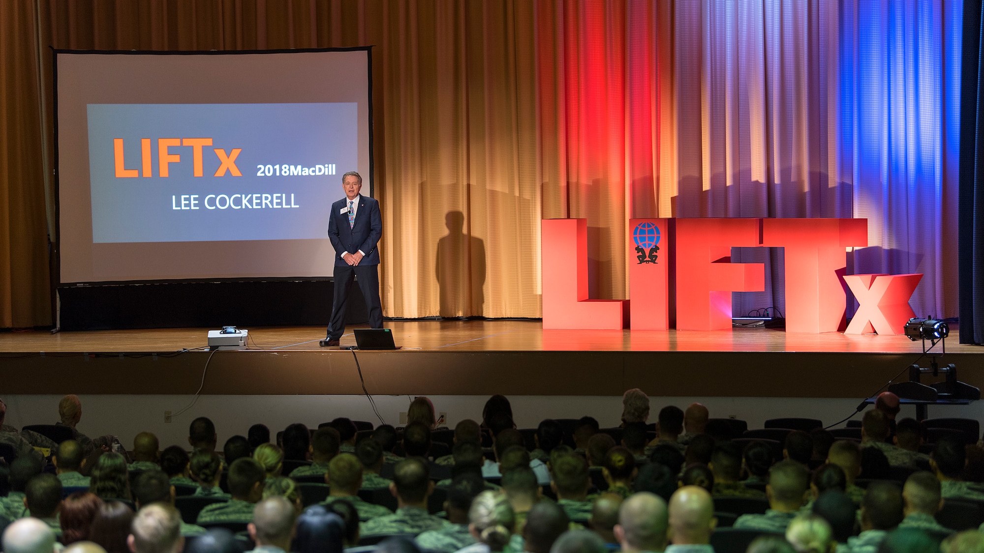 Lee Cockerell, former executive vice president of operations for the Walt Disney World Resort, speaks during the Leaders Inspiring for Tomorrow seminar hosted by MacDill Air Force Base, Fla., April 19, 2018. Cockerell spoke on the merits of time management and different tactics to prioritize tasks in life. LIFTx brought together 10 diverse speakers from around the country who shared their stories of leadership, inspiration, innovation and resiliency.