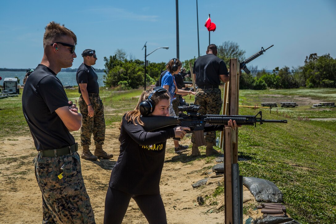 Catherine Redden, an attendee of the Educators Workshop, fires an M16-A4 service rifle aboard Marine Corps Recruit Depot Parris Island, South Carolina, April 18, 2018. These educators traveled from Recruiting Station (RS) Baton Rouge and RS Columbia to experience the workshop. The workshop allows educators to have an inside look at educational benefits and career opportunities in the Marine Corps to better inform their students. (U.S. Marine Corps photo by Cpl. Jorge A. Rosales)