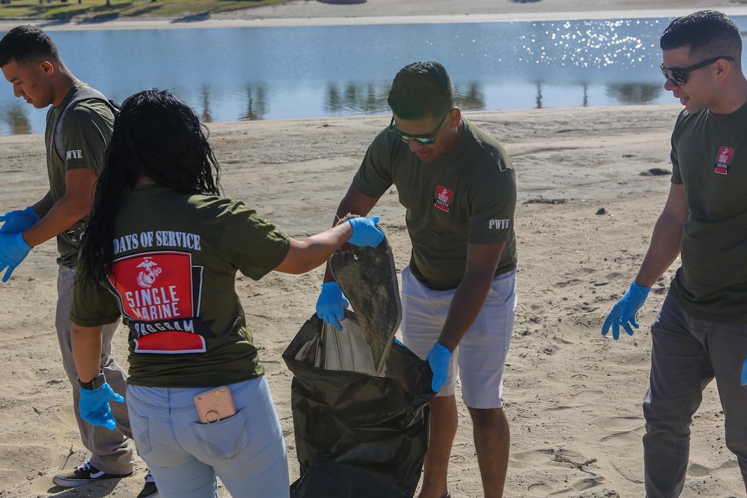 Marines with Marine Corps Air Station Miramar’s Single Marine Program dispose of trash during a beach cleanup at Fiesta Island in San Diego, April 17. Marines volunteered as part of the SMP’s “Days of Service,” an initiative across several SMP offices, to recognize National Volunteer Month. During "Days of Service," Marines and Sailors supported local communities by conducting cleanups, volunteering at animal shelters and organizations that help veterans. (U.S. Marine Corps photo by Cpl. Daniel Auvert/Released)