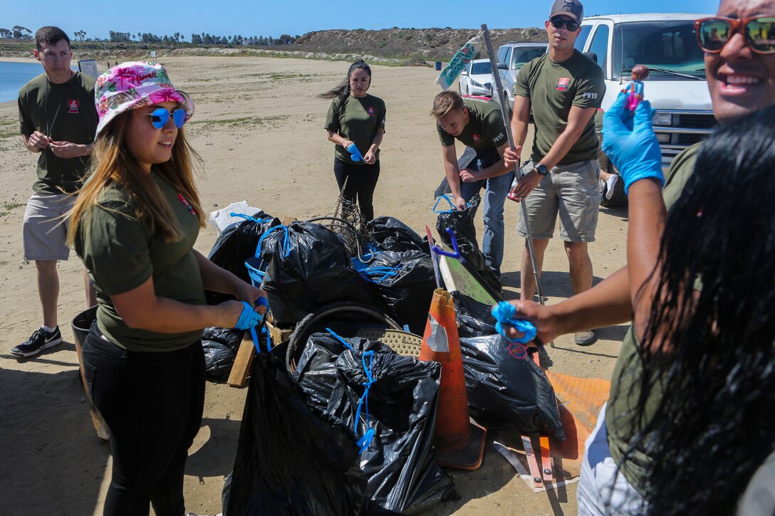 Marines with Marine Corps Air Station Miramar’s Single Marine Program sort the trash they collected during a beach cleanup on Fiesta Island in San Diego, April 17. Marines volunteered as part of the SMP’s “Days of Service,” an initiative across several SMP offices, to recognize National Volunteer Month. During "Days of Service," Marines and Sailors supported local communities by conducting cleanups, volunteering at animal shelters and organizations that help veterans. (U.S. Marine Corps photo by Cpl. Daniel Auvert/Released)