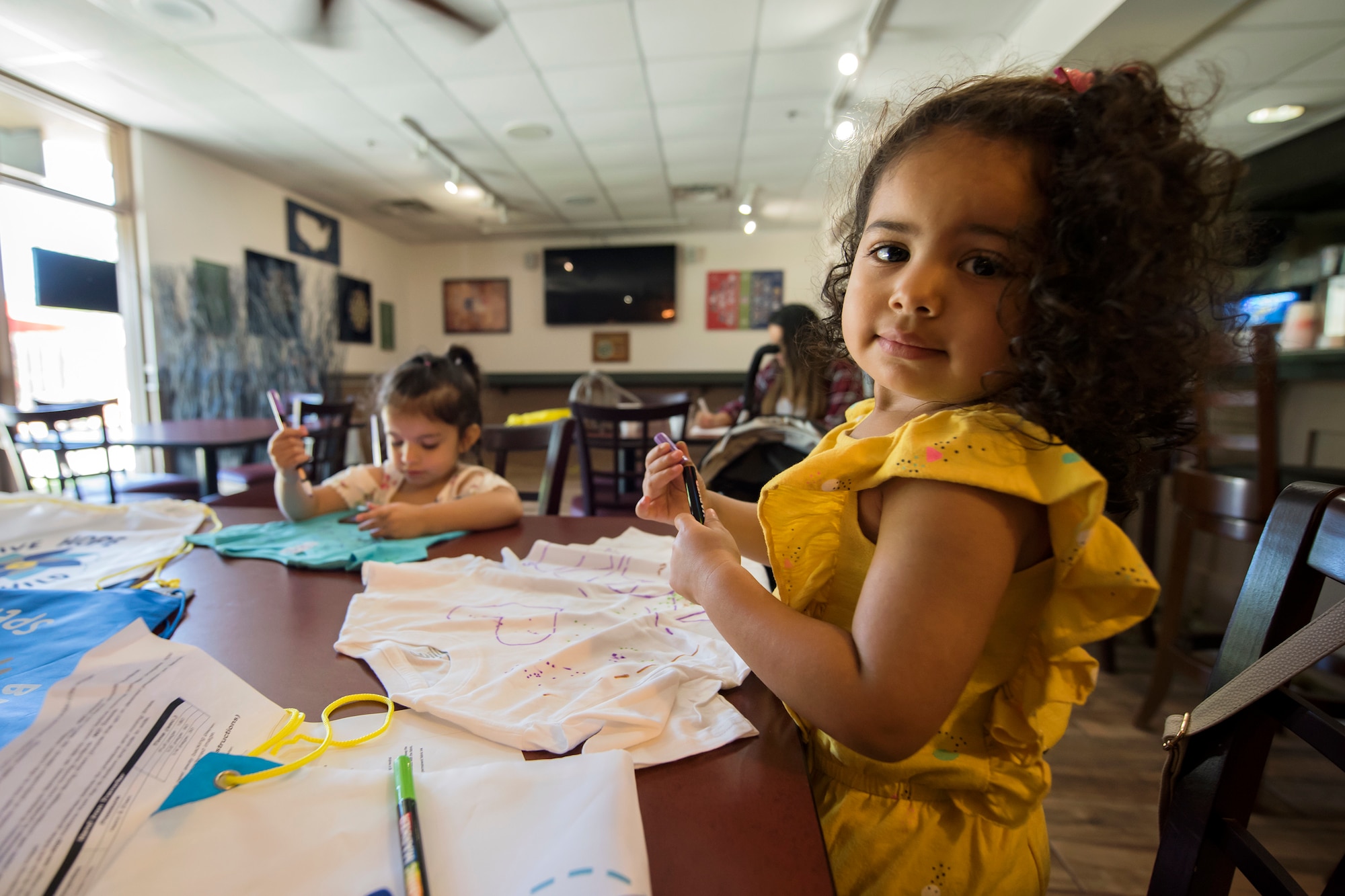 Children design T-shirts during a baby shower, April 14, 2018, at Moody Air Force Base, Ga. The baby shower provided attendants with various gifts and educational opportunities, the shower’s main focus this year was on raising awareness to the issue of child abuse. (U.S. Air Force photo by Airman 1st Class Eugene Oliver)