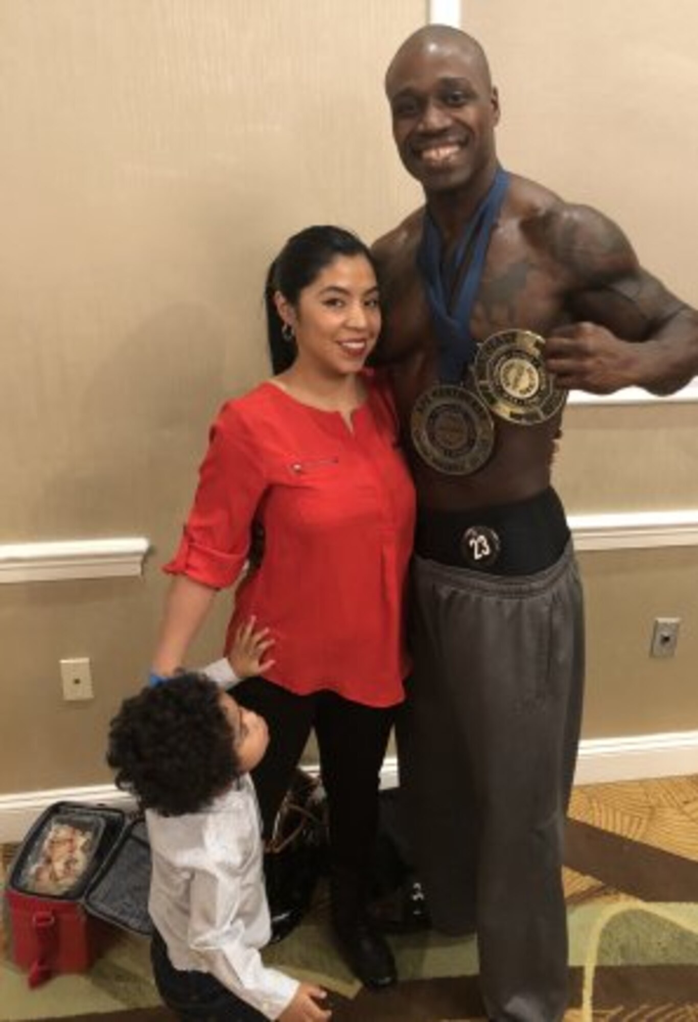 Capt. Kevon Reid poses with his wife, Vania and son, Alexander at the 2018 Steve Stone Metropolitan Bodybuilding Championships in Teaneck, New Jersey Mar. 31. Capt. Reid is an Observer Coach/Trainer with the 174th Infantry Brigade at Joint Base McGuire-Dix-Lakehurst, New Jersey. (Courtesy Photo) (Photo Credit: U.S. Army)