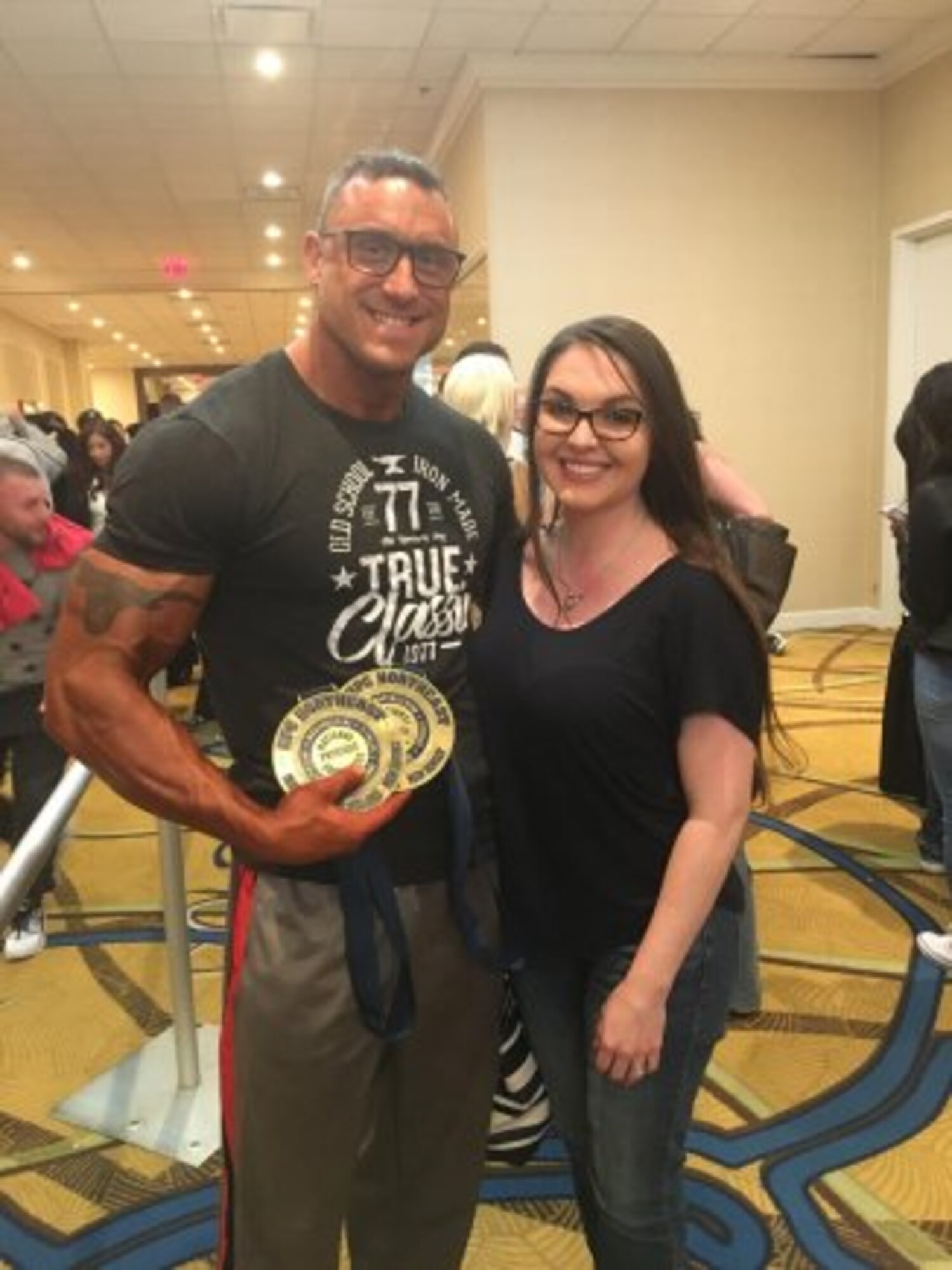 Staff Sgt. Jamie Kedrowicz and his wife Alexia pose with his first place awards at the 2018 Steve Stone Metropolitan Bodybuilding Championships in Teaneck, New Jersey Mar. 31. Staff Sgt. Kedrowicz is an Observer Coach Trainer with the 174th Infantry Brigade at Joint Base McGuire-Dix-Lakehurst, New Jersey. (Courtesy Photo). (Photo Credit: U.S. Army)