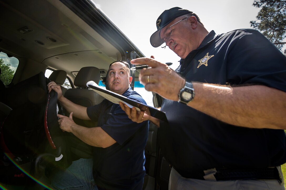 Mitch Griffin, right, Lowndes County deputy sheriff coordinator, conducts a car seat safety check during a baby shower, April 14, 2018, at Moody Air Force Base, Ga. The baby shower provided attendants with various gifts and educational opportunities, the shower’s main focus this year was on raising awareness to the issue of child abuse. (U.S. Air Force photo by Airman 1st Class Eugene Oliver)