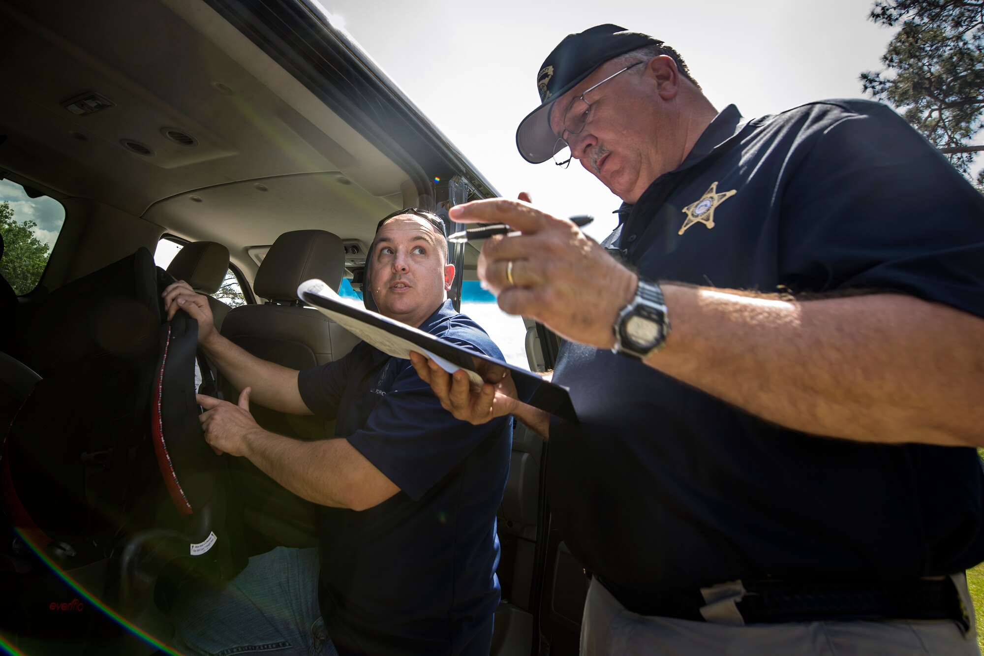 Mitch Griffin, right, Lowndes County deputy sheriff coordinator, conducts a car seat safety check during a baby shower, April 14, 2018, at Moody Air Force Base, Ga. The baby shower provided attendants with various gifts and educational opportunities, the shower’s main focus this year was on raising awareness to the issue of child abuse. (U.S. Air Force photo by Airman 1st Class Eugene Oliver)