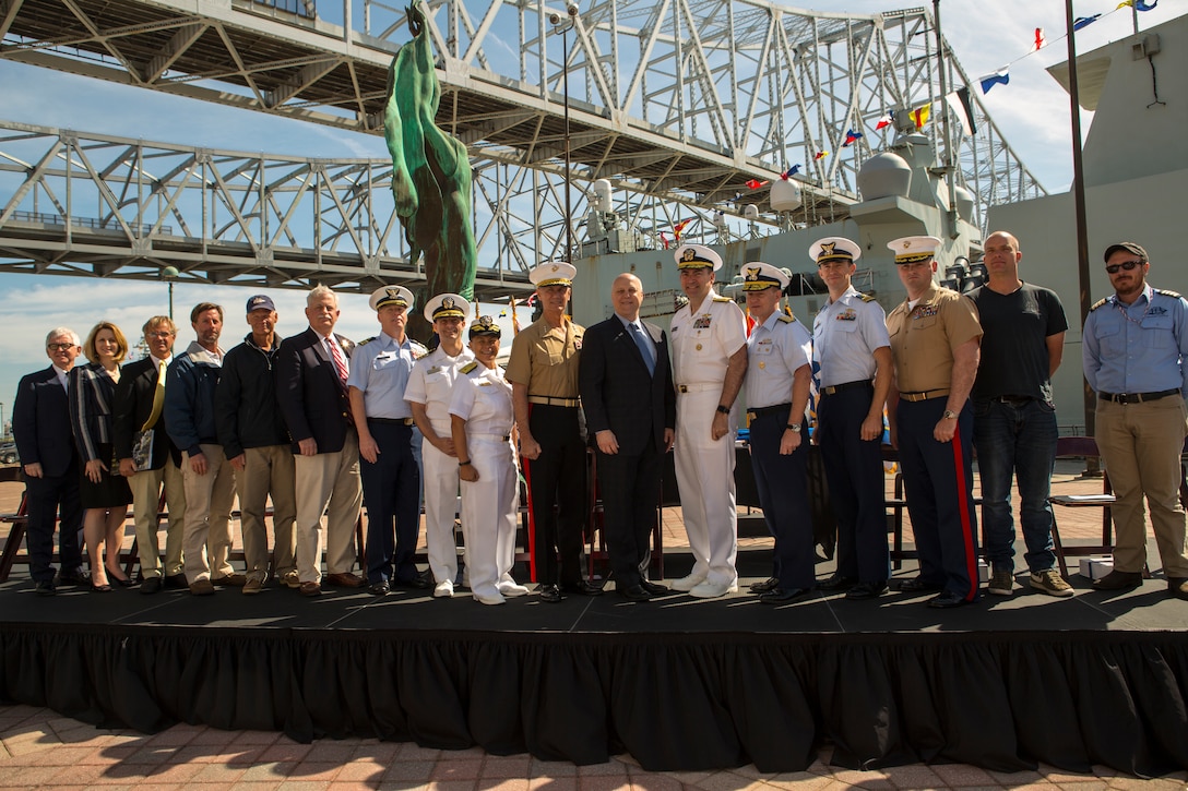 Service members and leaders of organizations pose for a picture during the mayoral welcome for Navy Week at the Port of New Orleans, April 20, 2018. The celebration is an opportunity for citizens of New Orleans and surrounding area to meet service members and witness the latest capabilities of today’s maritime service. (U.S. Marine Corps photo by Lance Cpl. Melany Vasquez/Released)