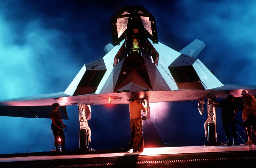 A back lit front view of an F-117 Nighthawk from Airman Magazine's February 1995 issue article "Streamlining Acquisition 101." The Lockheed F-117A was developed in response to an Air Force request for an aircraft capable of attacking high value targets without being detected by enemy radar. (Airman Magazine photo)