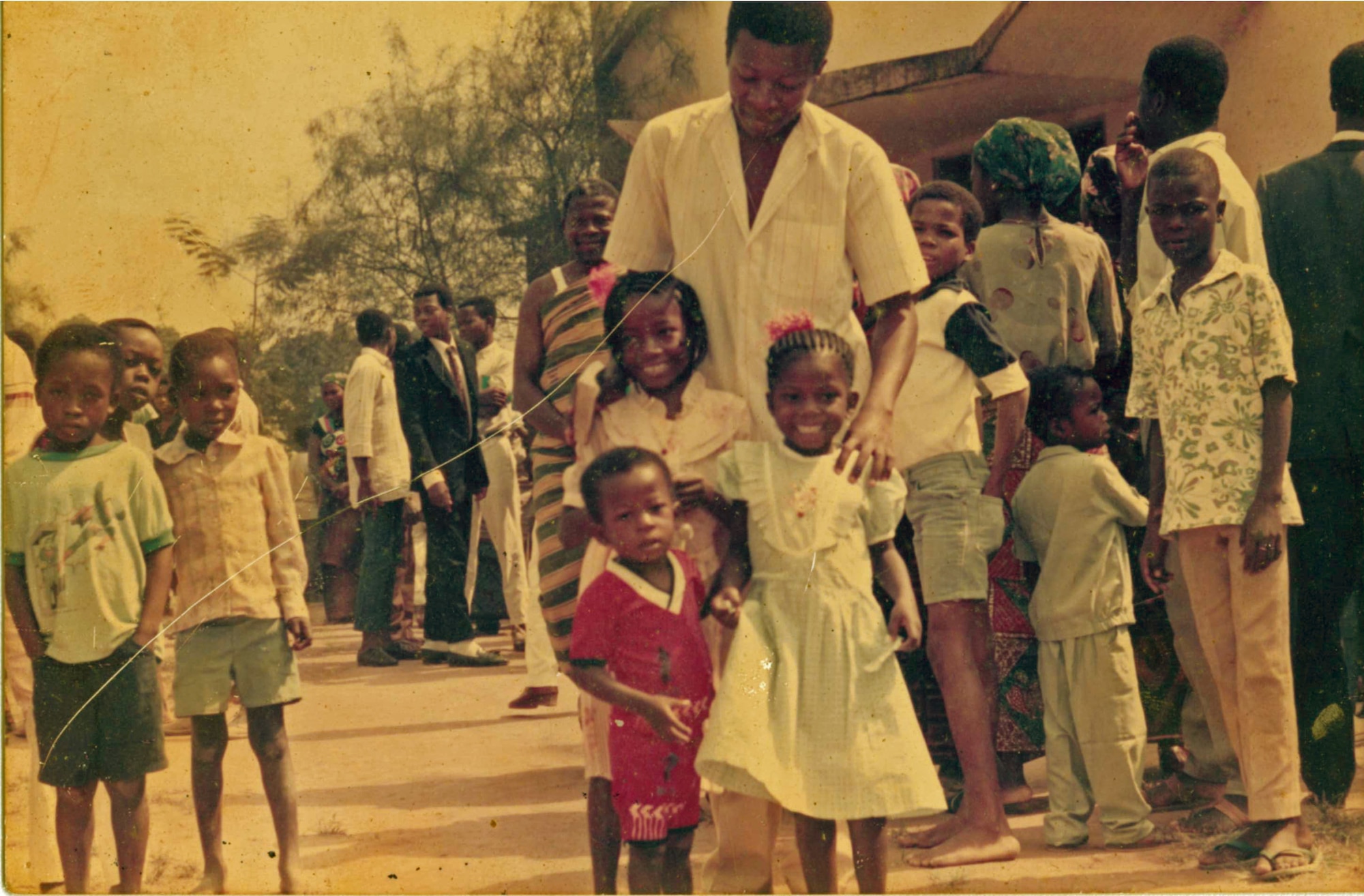 Airman 1st Class Kofi Combey Douhadji, 92nd Logistics Readiness Squadron vehicle operator, poses for a photo after church on Christmas 1988, with his father and two older sisters. Douhadji is one of 11 children, all born and raised in Togo, a country in West Africa. (Courtesy Photo)