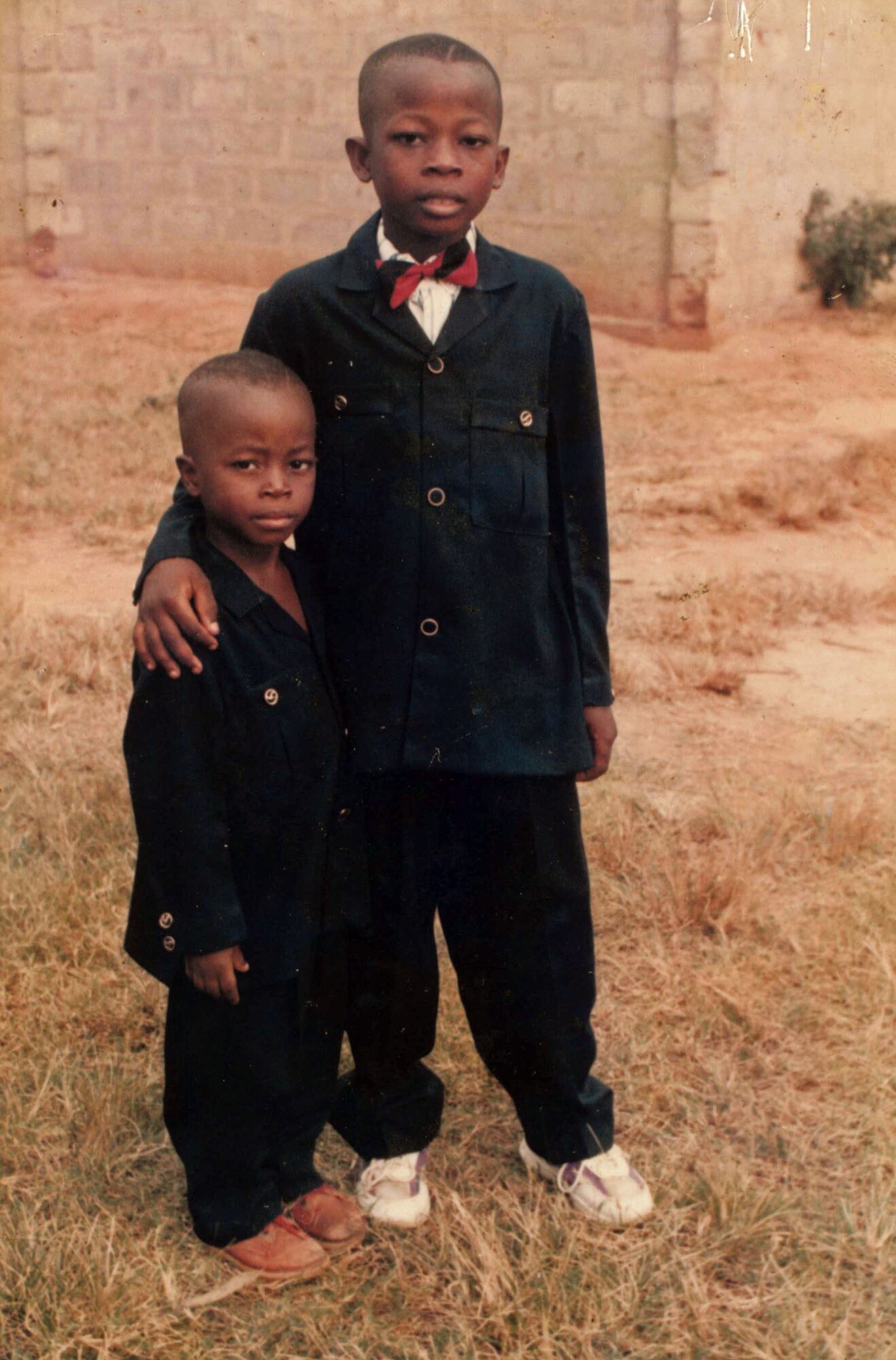 Airman 1st Class Kofi Combey Douhadji, 92nd Logistics Readiness Squadron vehicle operator, poses for a photo with his younger brother in Togo, where he lived until his family was selected by the online Diversity Visa Program to immigrate the U.S. The program provides a limited number of visas each fiscal year to a class of immigrants known as “diversity immigrants” from countries with historically low rates of immigration to the U.S. (Courtesy Photo)