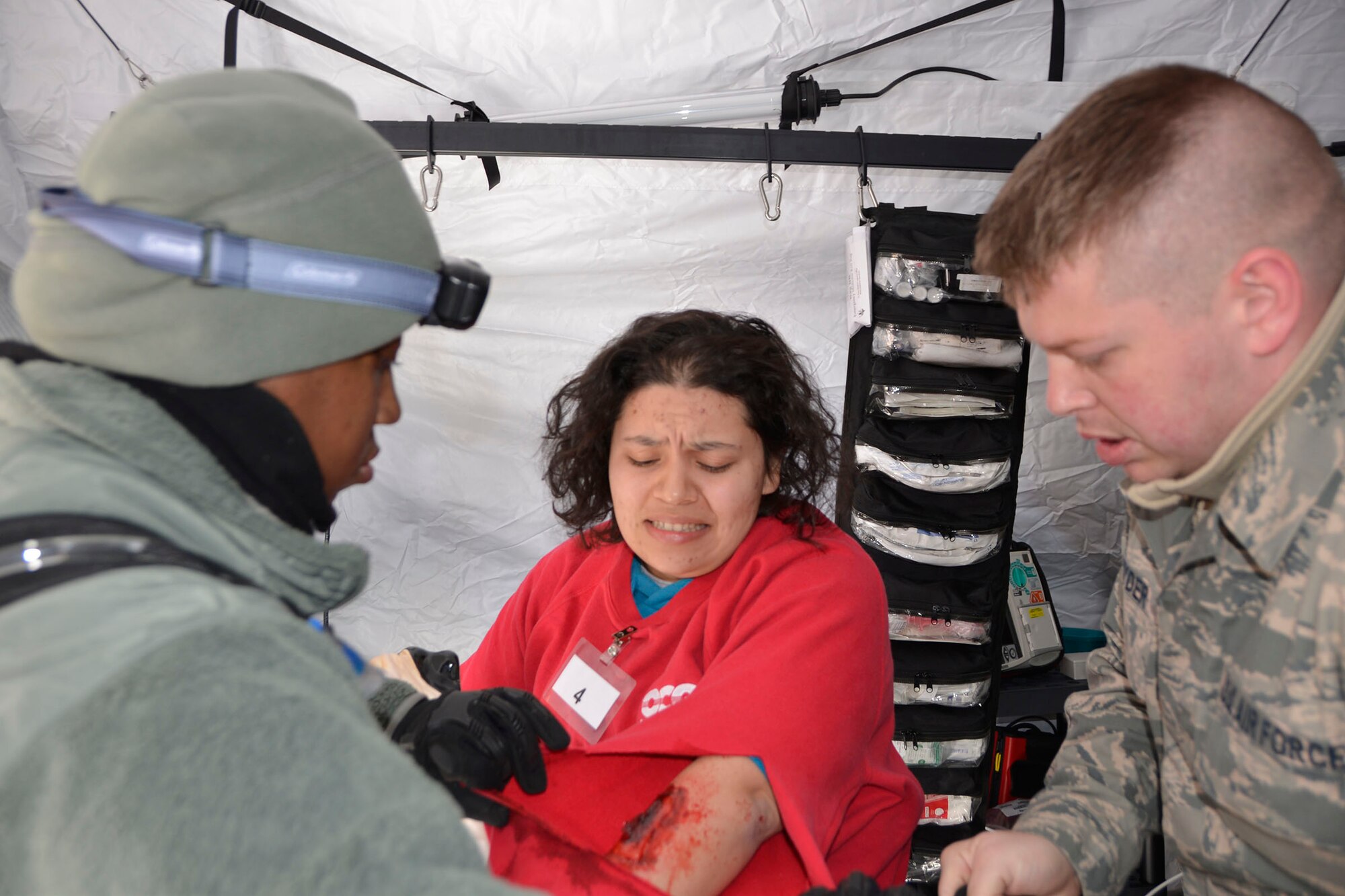 Staff Sgt. Khaliha Love and Senior Airman Glen Snyder, from the 81st Medical Group medics, treat a simulated patient during the Expeditionary Medical Support field confirmation exercise at Camp Atterbury, Indiana, April 17, 2018. The confirmation exercise evaluated the tactics, techniques and procedures of EMEDS operations during a domestic U.S. contingency such as a natural disaster. (U.S. Air Force photo by Mary McHale)