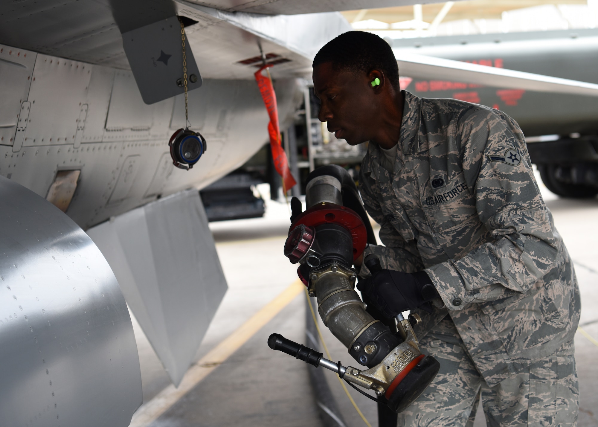Airman Johnny Jackson, 56th Logistics Readiness Squadron fuels operations distributor, prepares to connect a fuel hose to an F-16 Fighting Falcon April 19, 2018, at Luke Air Force Base, Ariz. Jackson was part of a 56th LRS team that won a fuel truck competition, beating out teams from Davis-Monthan AFB, Ariz. and Nellis AFB, Nev. (U.S. Air Force photo by Airman 1st Class Aspen Reid)