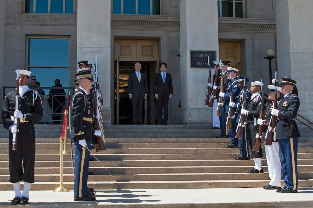 Defense Secretary James N. Mattis stands next to the Japanese defense minister during an honor cordon.