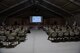 Col. Gonzales speaks to more than 100 Airmen in a large tent