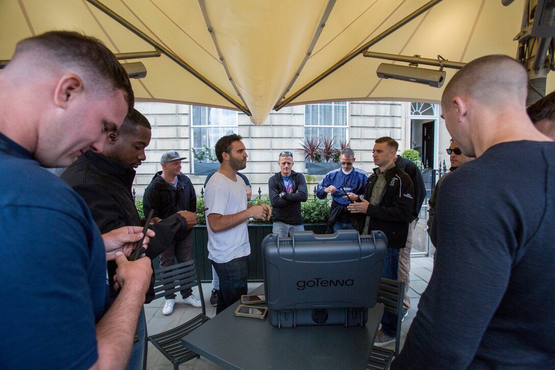 Jorge Perdomo (center), founder and chief executive officer or goTenna, talks to  Reserve Marines with 4th Air Naval Gunfire Liaison Company, Force Headquarters Group, about new radio opportunities that would aide them in future operations, in Edinburgh, Scotland, April 20, 2018.