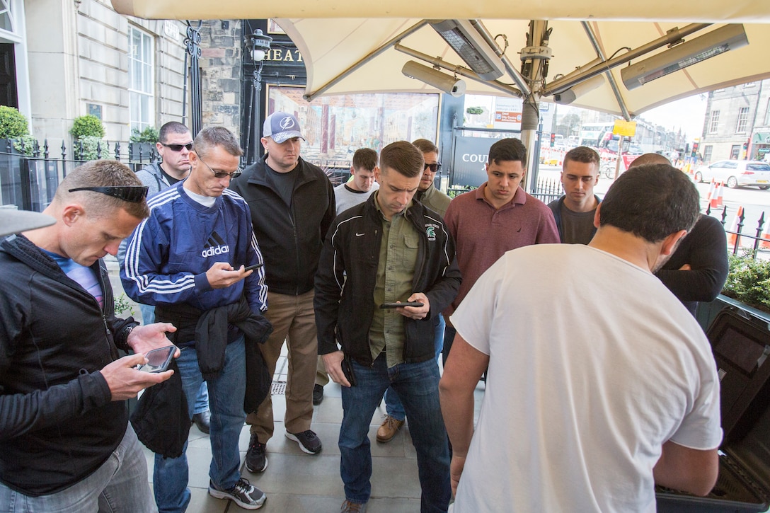 Reserve Marines with 4th Air Naval Gunfire Liaison Company, Force Headquarters Group, listen to Jorge Perdomo (right), founder and chief executive officer of goTenna, as he discusses new and emerging communication technologies, in Edinburgh, Scotland, April 20, 2018.