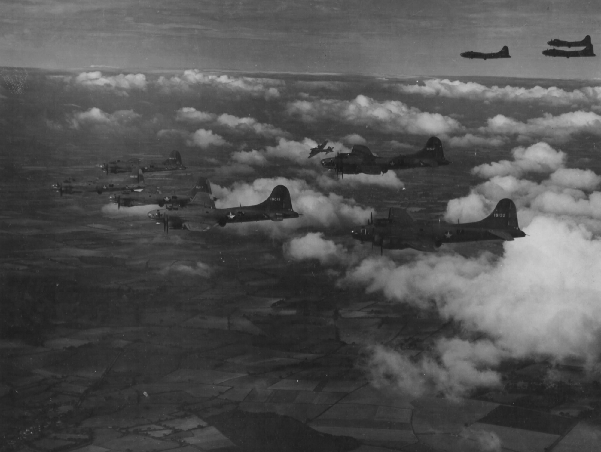 On August 17, 1942, twelve B-17Es struck the railroad marshalling yards at Rouen-Sotteville in France, marking the first Eighth Air Force heavy bomber raid.  Many of the aircraft used on this first raid are seen here on a training exercise over England.