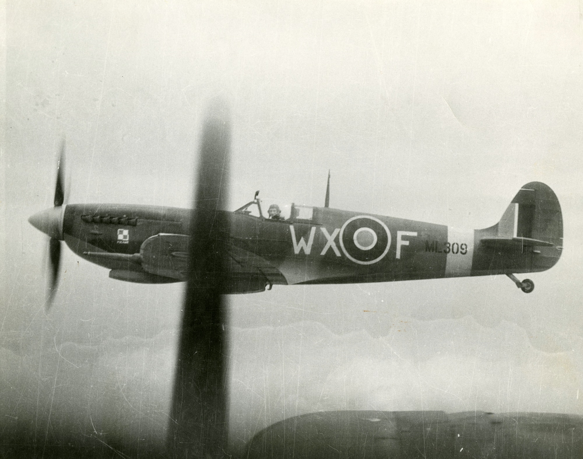Royal Air Force (RAF) Spitfire off the wing of a B-17.  Flown by RAF and American pilots, the short-ranged Spitfire was the USAAF’s heavy bomber escort until mid-1943.