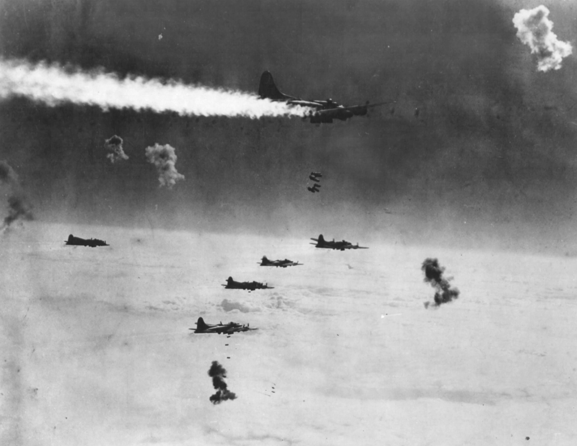 Despite being on fire and surrounded by flak bursts, this B-17 stayed in formation to drop its bombs on Berlin.  The bombers were most vulnerable on the bomb run, when they had to fly straight and level for several minutes to ensure accuracy.