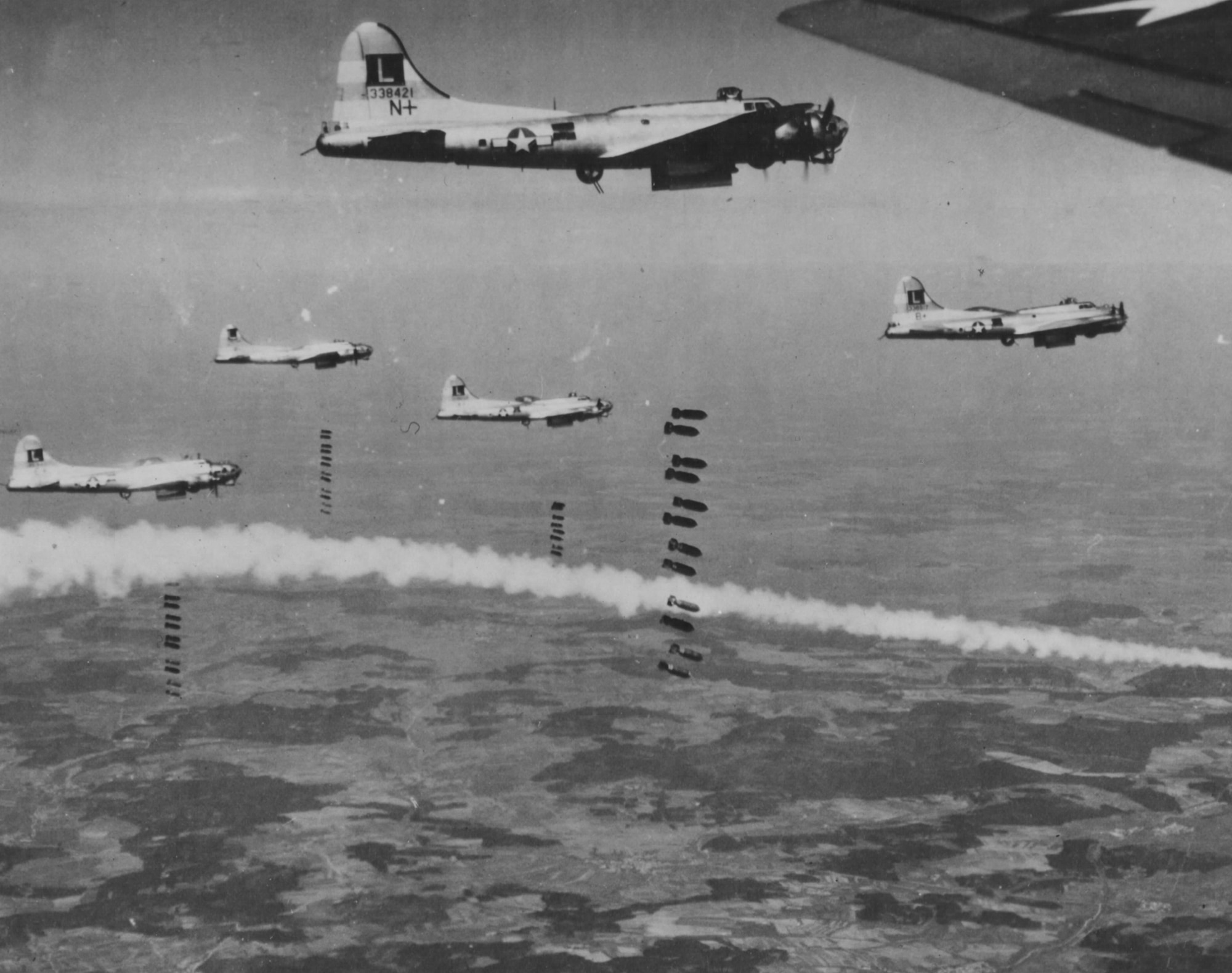Eighth Air Force B-17s bombing the railroad yards in Donauworth, Germany, in April 1945.  The smoke is from a marker signaling the bomb drop.