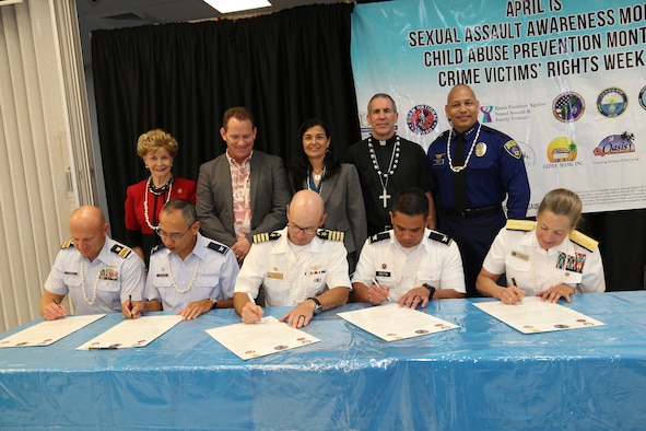 Joint Region Marianas (JRM) military and civilian community leaders sign a joint proclamation, declaring April 2018 as Sexual Assault Awareness and Prevention & Child Abuse Prevention Month, during a ceremony, April 3, 2018. The Joint military proclamation was signed by U.S. Navy Rear Adm. Shoshana Chatfield, commander, JRM; Capt. Hans Sholley, commanding officer, Naval Base Guam; U.S. Air Force Col. Joel Almosara, 36th Medical Group commander; U.S. Coast Guard Capt. Christopher Chase, commander, U.S. Coast Guard Sector Guam; and U.S. Army Col. Ronnie Delfin, for Maj. Gen. Roderick R. Leon Guerrero, the adjutant general for the Guam National Guard. The JRM Proclamation calls upon military personnel and their families to increase their participation in our efforts to prevent sexual assault and child abuse, thereby strengthening the island community. (Air National Guard courtesy photo)