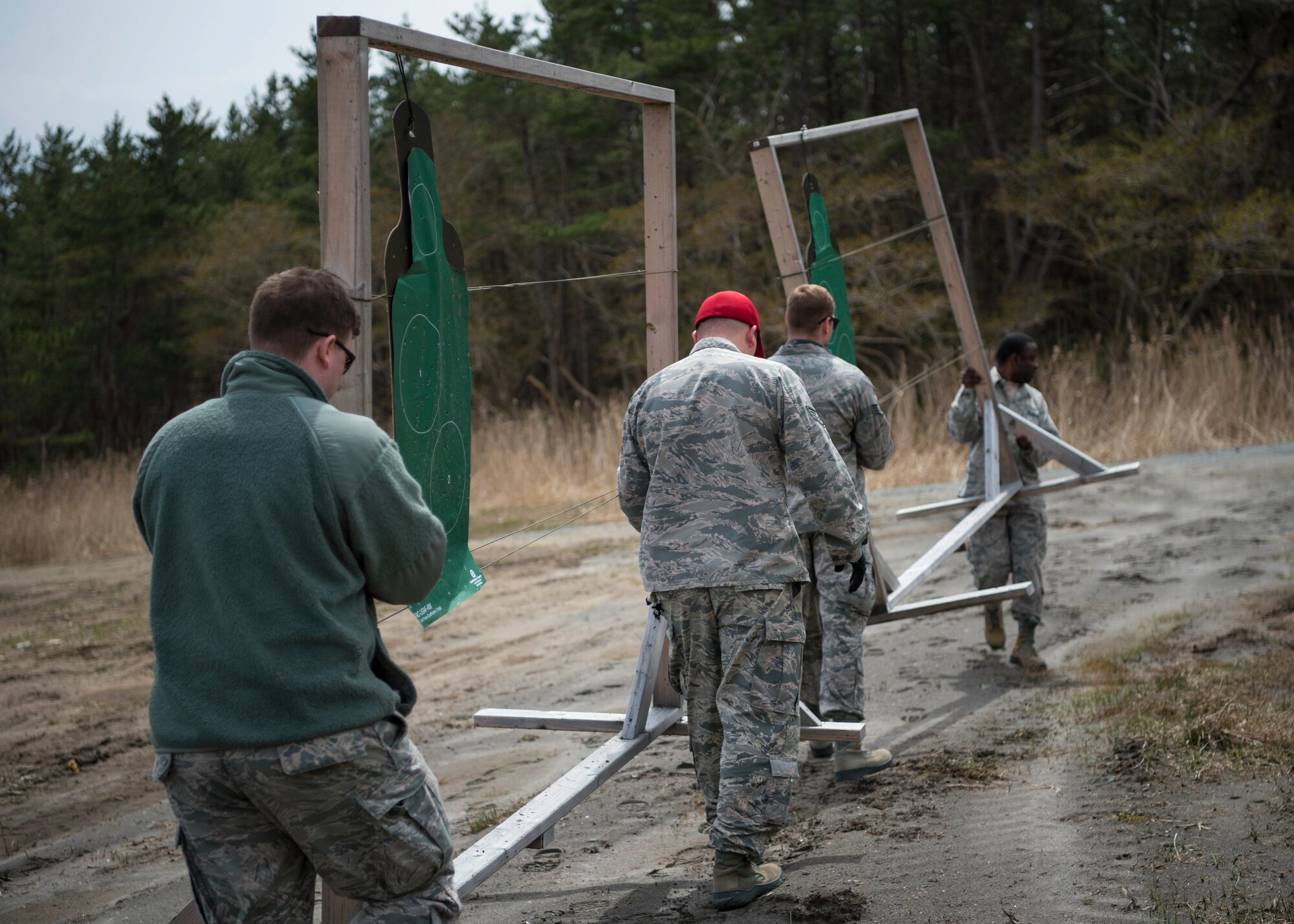 Members with the 35th Security Forces Squadron and 35th Aerospace Medicine Squadron move practice targets from the new Combat Arms Training and Maintenance outdoor firing range at Draughon Range adjacent Misawa City, Japan, April 18, 2018. Conceptualized nearly three years ago, the outdoor range provides CATM six times more space to qualify Airmen on a variety of weapons. The current indoor range can qualify seven Airmen at one time, where the outdoor range serves 40. (U.S. Air Force photo by Staff Sgt. Deana Heitzman)