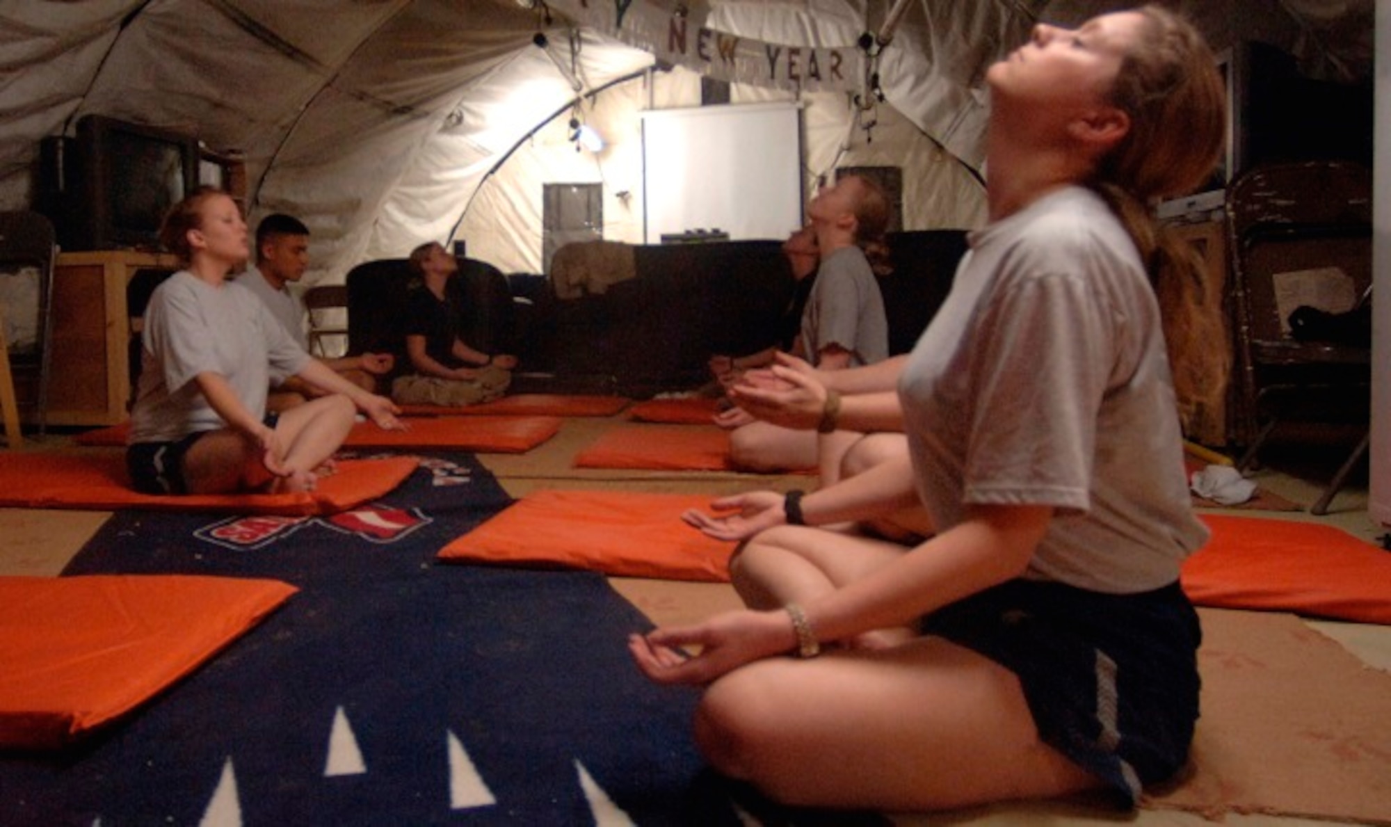 Airmen and Soldiers practice breathing and relaxation during their off duty time in a deployed location. Stress can take its toll on your mental and physical health, including your heart health, but there are breathing techniques to buffer yourself from it. (U.S. Air Force photo by Master Sgt. Lance Cheung)