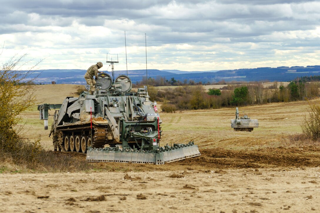 A British soldier prepares a Terrier armored digger.