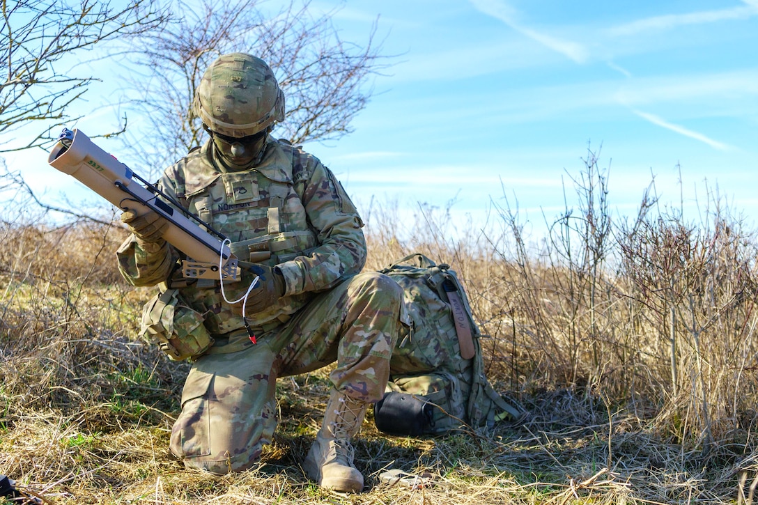 A soldier prepares to launch an aerial missile system.