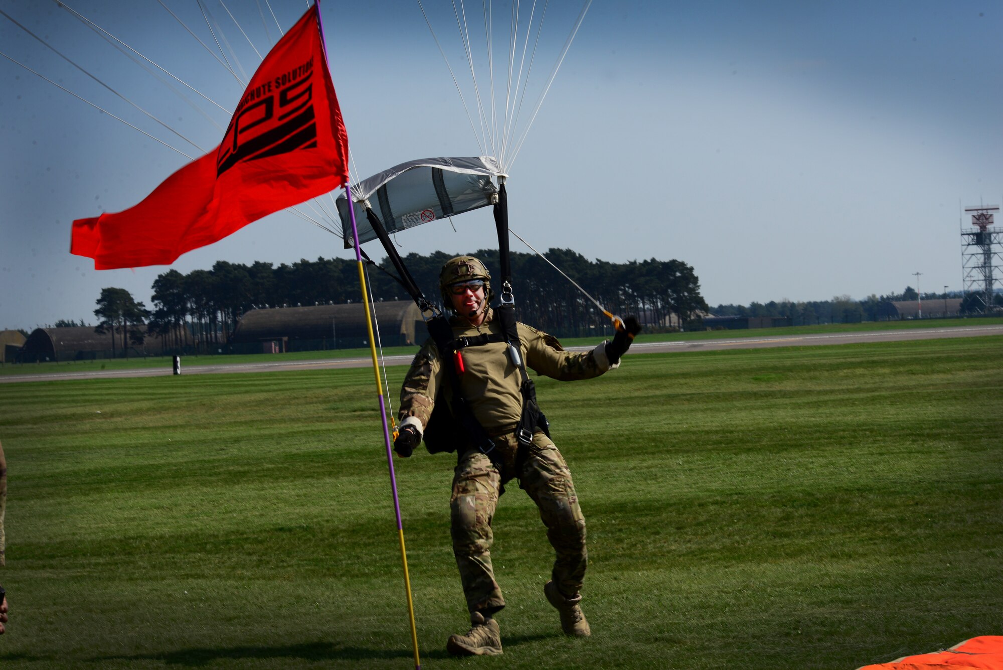 A pararescueman assigned to the 57th Rescue Squadron completes his final jump over Royal Air Force Lakenheath, England April, 20. The event signals the final phase of the two squadrons relocation to Aviano Air Base, Italy this spring. (U.S. Air Force photo/Tech. Sgt. Matthew Plew)