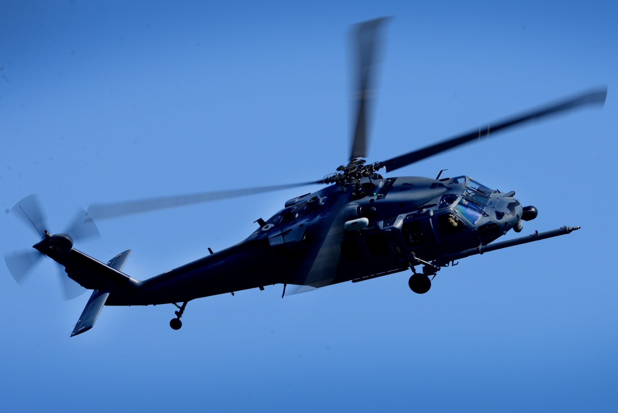 An HH-60G Pave Hawk assigned to the 56th Rescue Squadron flies over Royal Air Force Lakenheath, England, in support of the final jump for pararescue Airmen assigned to the 57th RQS April, 20. The event signals the final phase of the two squadrons relocation to Aviano Air Base, Italy this spring.  (U.S. Air Force photo/Tech. Sgt. Matthew Plew)
