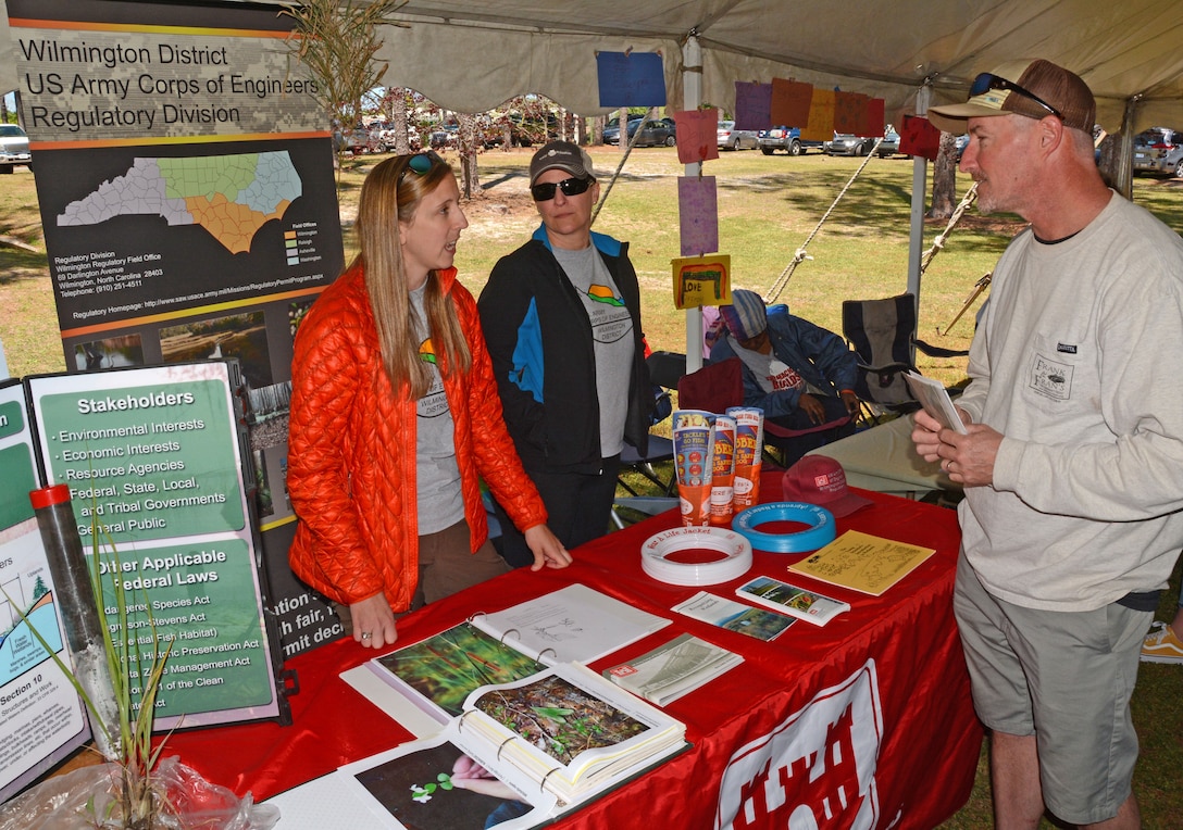Regulatory Project Manager Rachel Capito, left, explains the role of the U.S. Army Corps of Engineers' Regulatory Program to an interested attendee at Wilmington's Earth Day Festival. Also on hand to explain the mission is Regulatory Project Manager Emily Greer, right.